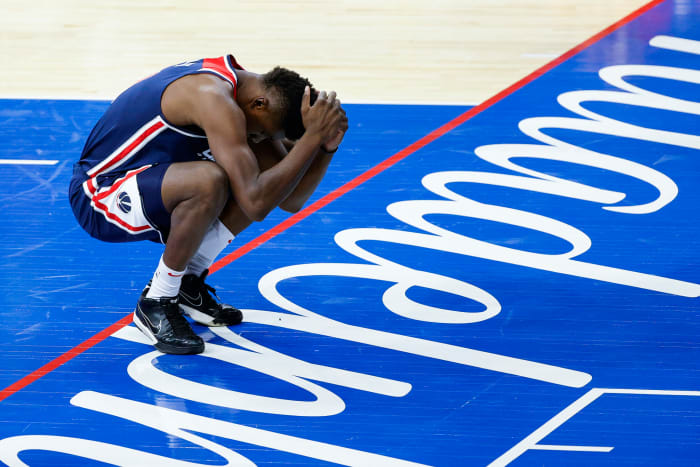 Washington Wizards center Thomas Bryant holds his head, reacting to a play.