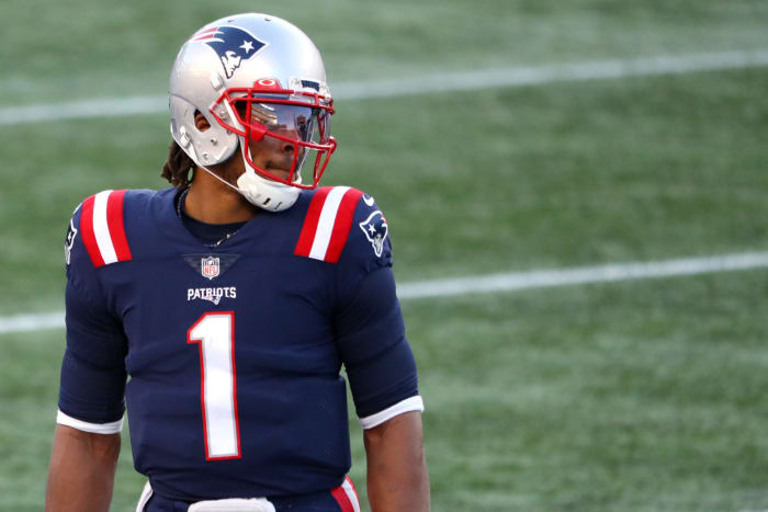 New England Patriots quarterback Cam Newton looks down the field.