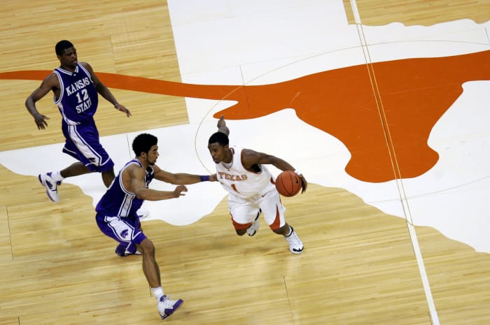 Daniel Gibson dribbling over the Texas Longhorns center court logo.