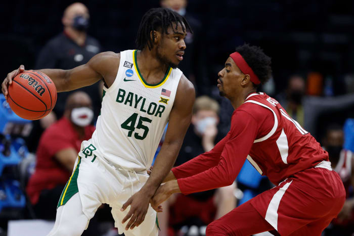 Davion Mitchell #45 of the Baylor Bears drives against Jalen Tate #11 of the Arkansas Razorbacks