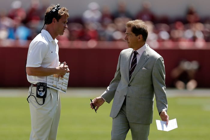 Nick Saban talking to Lane Kiffin before an Alabama football game.
