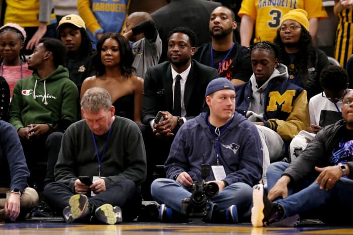 Dwyane Wade and Gabrielle Union at a Marquette basketball game.