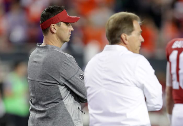 Offensive coordinator Steve Sarkisian of the Alabama Crimson Tide stands alongside head coach Nick Saban before taking on the Clemson Tigers.