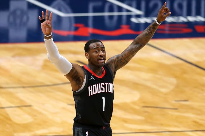 John Wall #1 of the Houston Rockets puts both arms up in the air