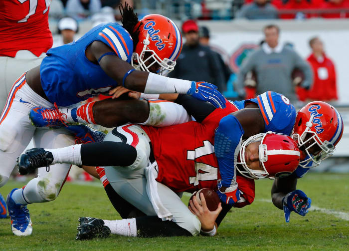 Florida Gators players sacking Georgia's quarterback.
