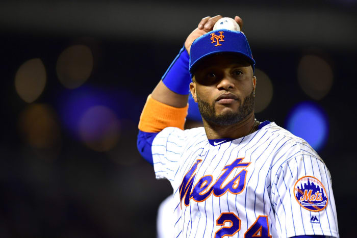 Mets second baseman Robinson Cano throws a baseball.