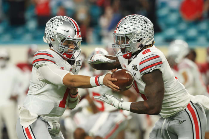 Trey Sermon takes a handoff from Justin Fields.