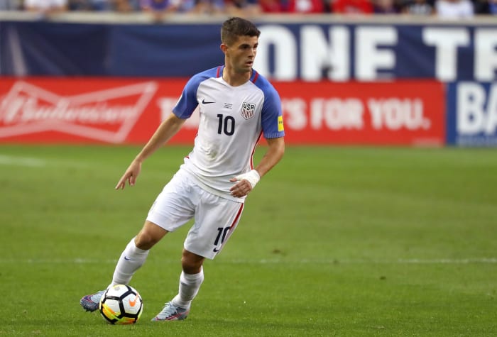 Christian Pulisic dribbling the ball for team USA soccer.