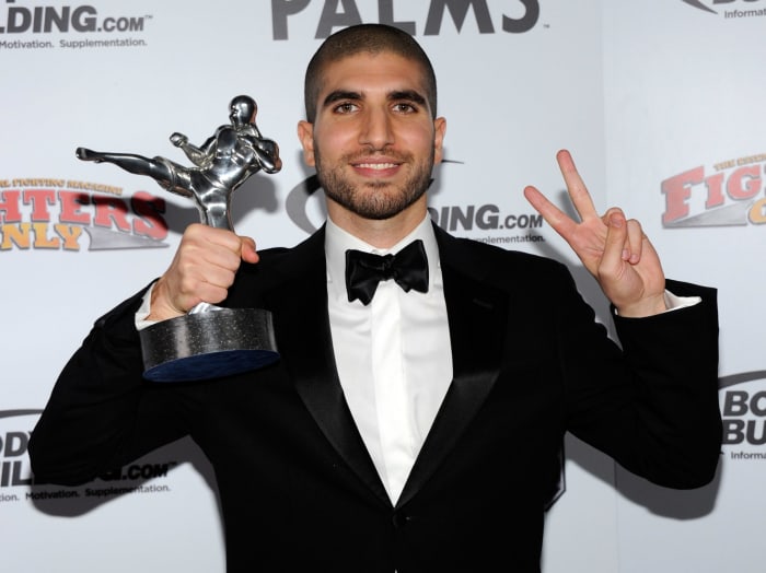 Ariel Helwani in a tux celebrating winning an award.