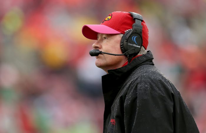 Bobby Petrino wearing a headset on the field for the Cardinals.