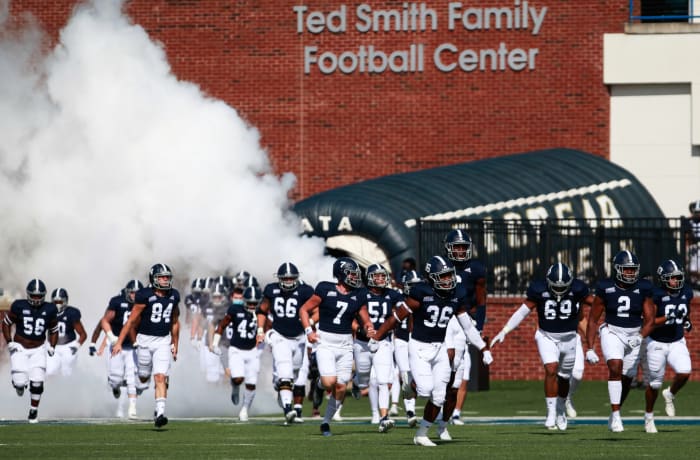 Georgia Southern football runs onto the field.