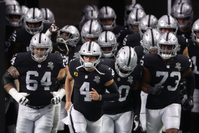Las Vegas Raiders including Derek Carr and Maurice Hurst run onto the field.