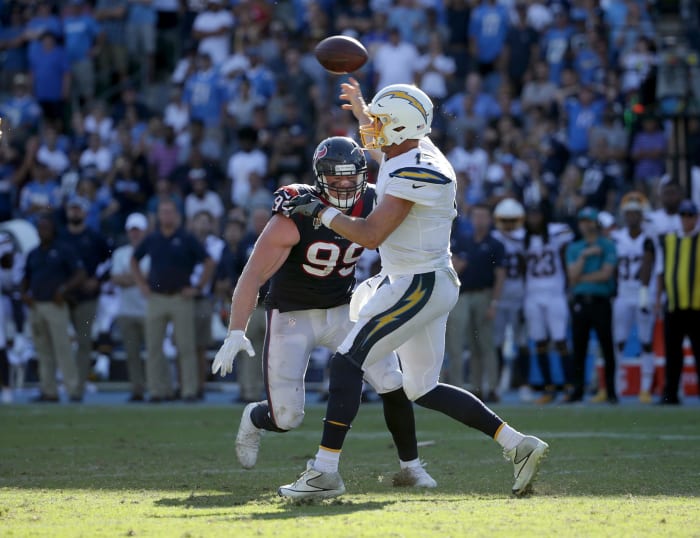 JJ Watt bears down on Philip Rivers, looking for a sack of the Chargers quarterback.