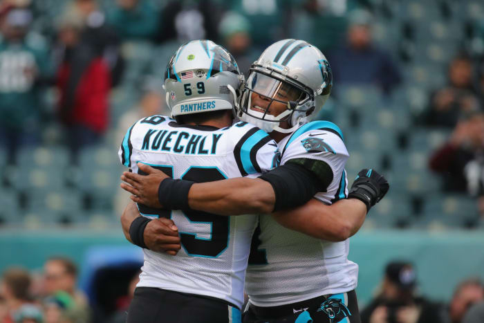 Carolina Panthers legends Cam Newton and Luke Kuechly hug.