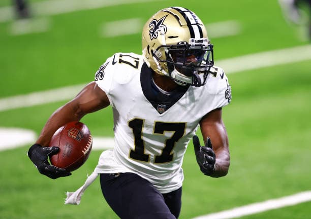 Emmanuel Sanders in Saints uniform carrying football