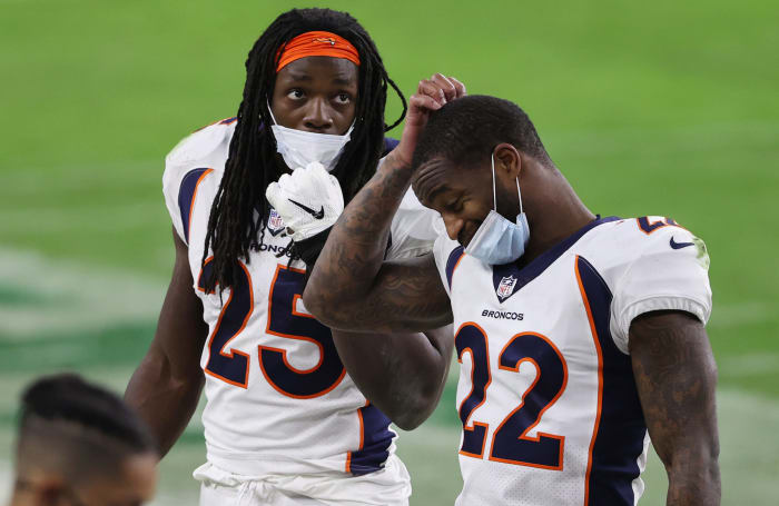 Kareem Jackson and Melvin Gordon on the field for the Broncos