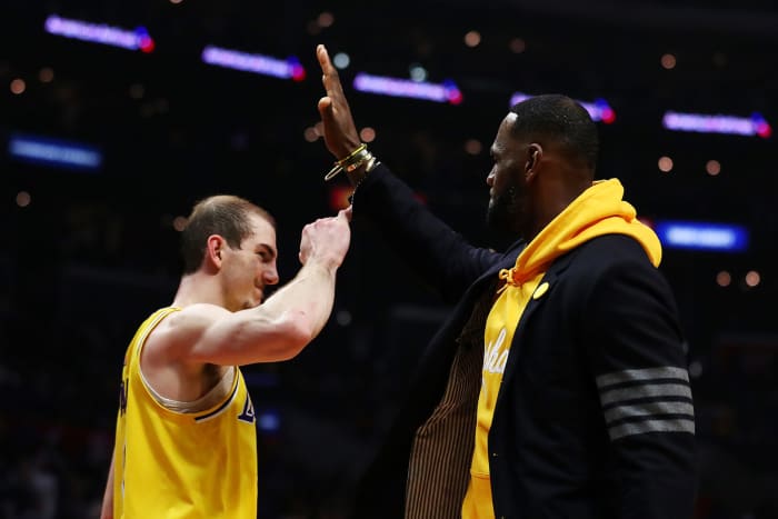 LeBron James high-fives Lakers teammate Alex Caruso.