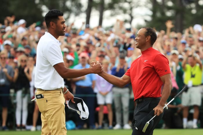 Tiger Woods shaking hands with Tony Finau.