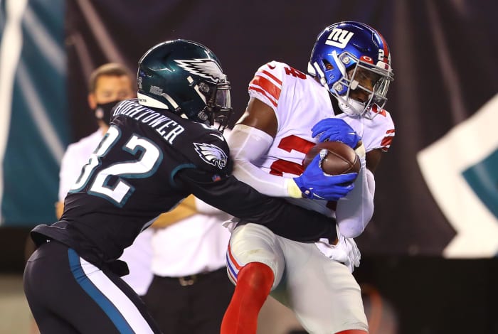 Giants player James Bradberry grabs the ball away from an Eagles player.