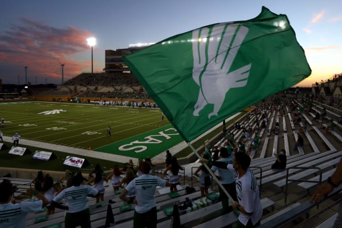 A North Texas fan waves a flag during the Mean Green college football game to open the 2020 season.