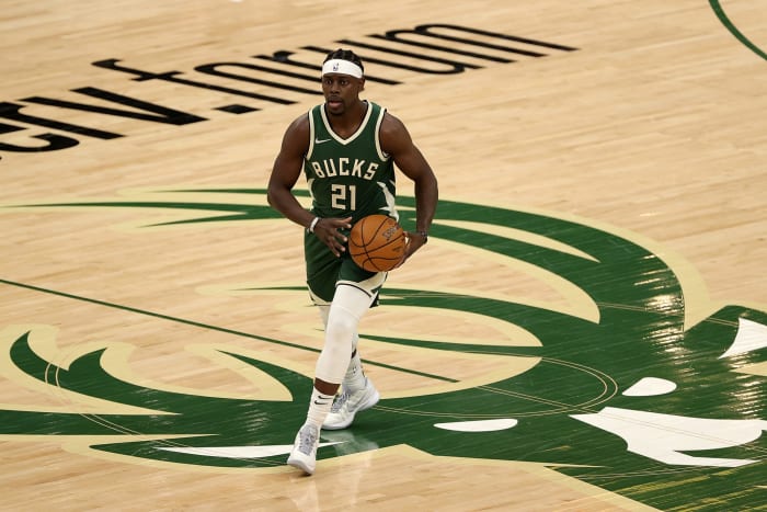 Jrue Holiday crosses half-court dribbling the basketball