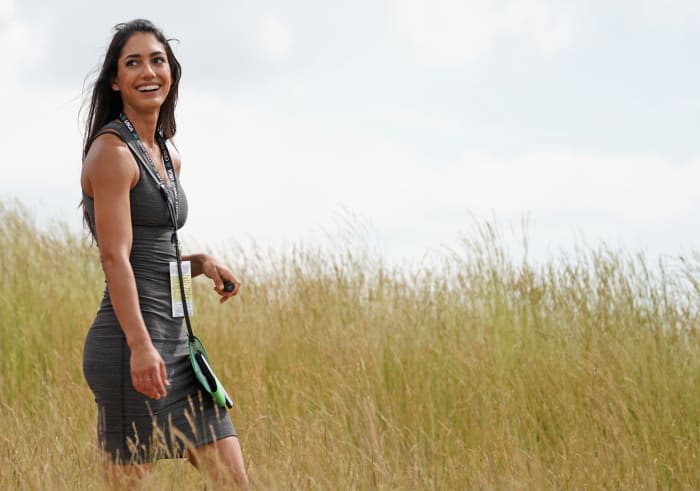 Allison Stokke walks through a golf course.