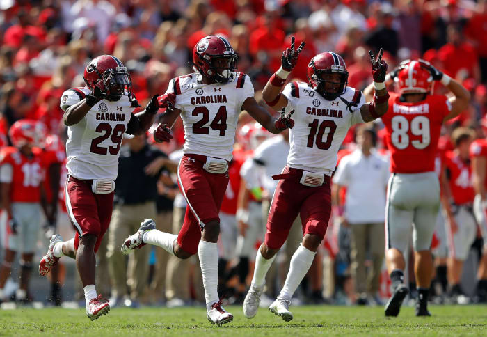 ATHENS, GEORGIA - OCTOBER 12: Israel Mukuamu #24 of the South Carolina Gamecocks reacts after his second interception of the game against the Georgia Bulldogs in the second half of their 20-17 second overtime win with J.T. Ibe #29 and R.J. Roderick #10 at Sanford Stadium on October 12, 2019 in Athens, Georgia. (Photo by Kevin C. Cox/Getty Images)