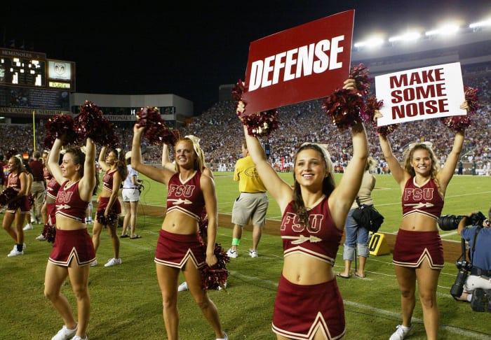 Florida State's cheerleaders holding up signs.