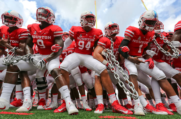 Houston Football players getting ready for a game by holding chains.