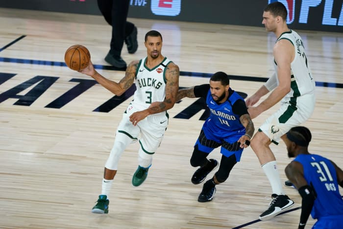 George Hill dribbles around the perimeter for the Bucks.