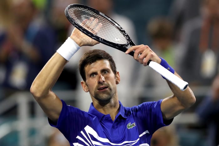 A closeup of Novak Djokovic celebrating after a victory.
