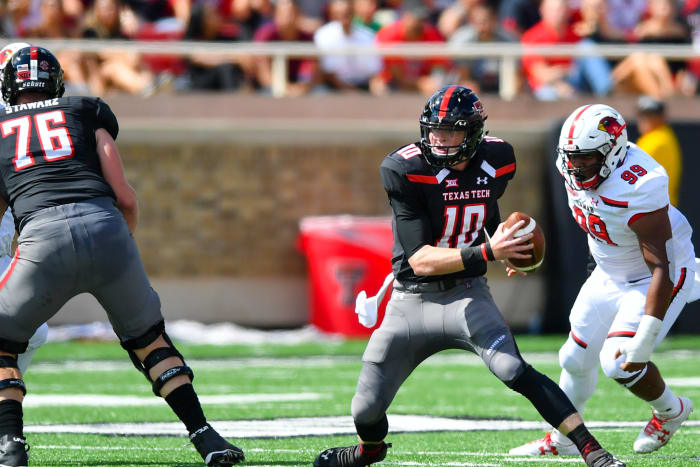 Alan Bowman runs with the ball for Texas Tech.