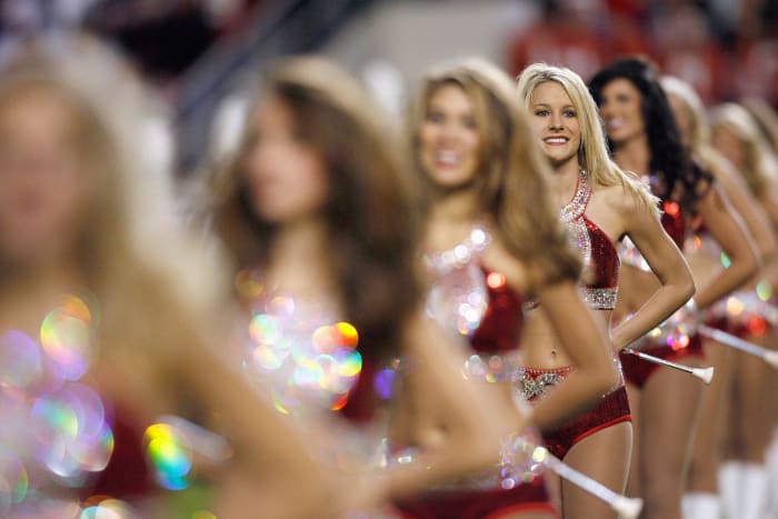 The flag girls of the Alabama Crimson Tide marching band perform before the game against the Mississippi State Bulldogs at Bryant-Denny Stadium.