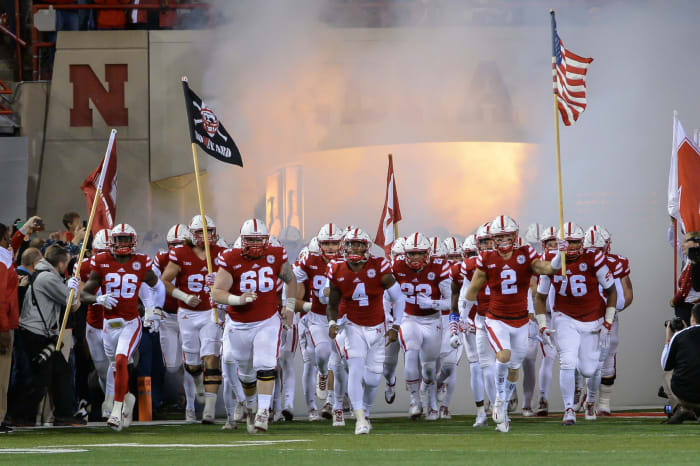 Quarterback Tommy Armstrong Jr. #4 of the Nebraska Cornhuskers leads the team on the field before the game.