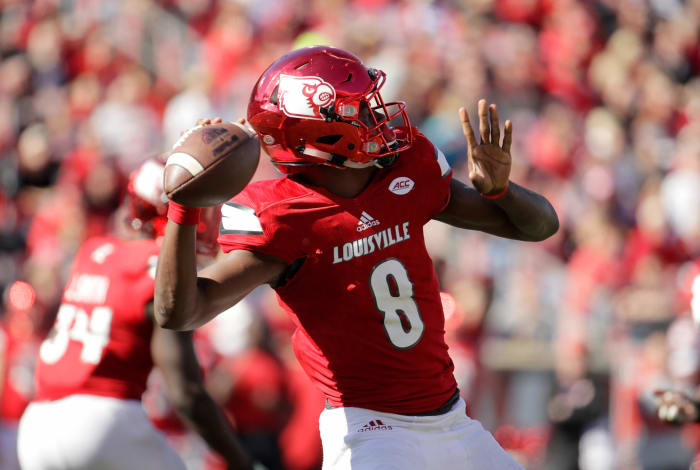A closeup of Lamar Jackson winding up to throw the football.