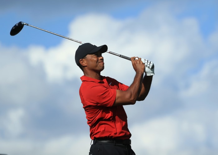 Tiger Woods in his follow through after hitting a golf ball.