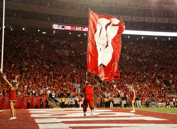 A Wisconsin cheerleader waves the flag after a score.