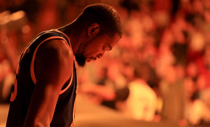 A closeup of Kevin Durant as he looks down before a game.