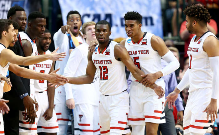 DALLAS, TX - MARCH 17: Keenan Evans #12 of the Texas Tech Red Raiders celebrates with teammates in the second half against the Florida Gators during the second round of the 2018 NCAA Tournament at the American Airlines Center on March 17, 2018 in Dallas, Texas. (Photo by Ronald Martinez/Getty Images)
