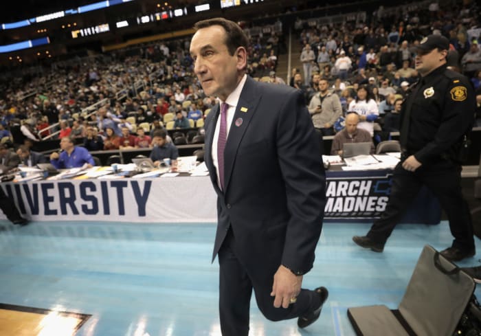 Coach K walks onto the court.