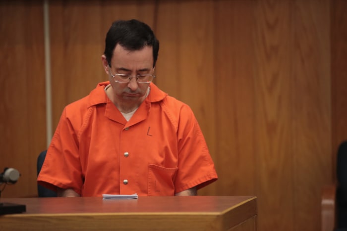 Larry Nassar wearing an orange prison jumpsuit.