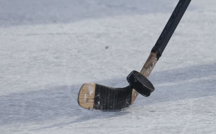 A hockey stick controlling the puck