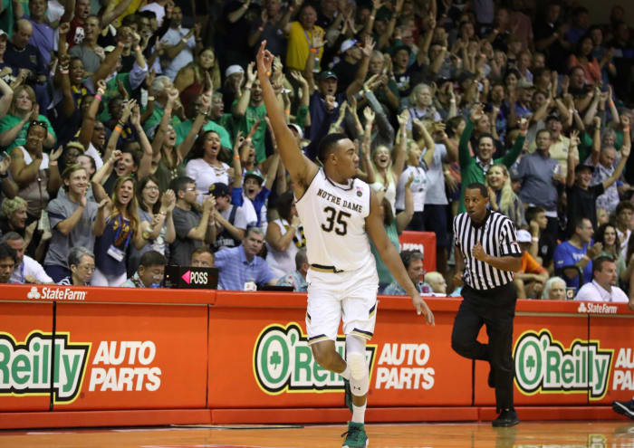Bonzie Colson running up the floor in a white notre dame basketball uniform.