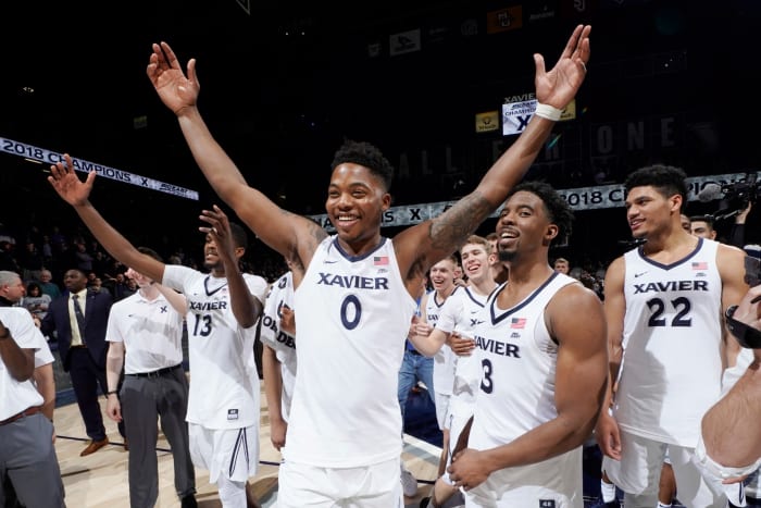 Xavier basketball players celebrate winning Big East.