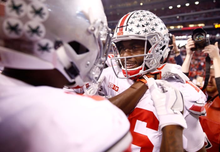 J.T. Barrett celebrating with his Ohio State teammates after a win.