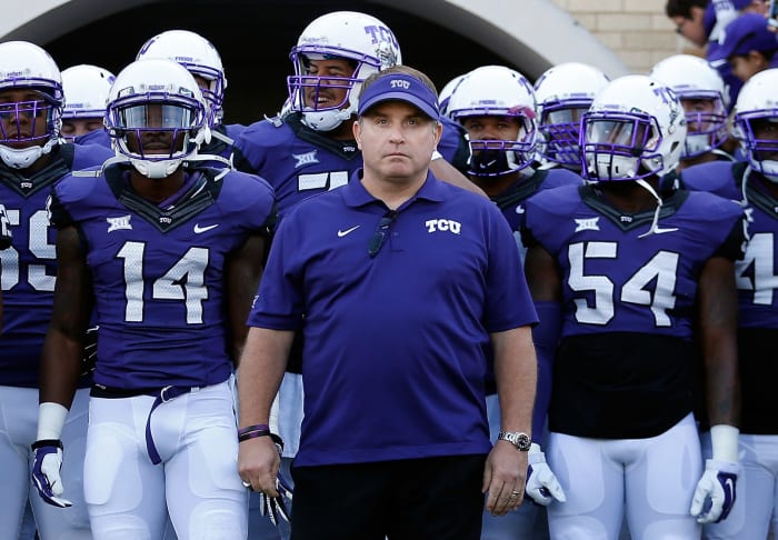 Gary Patterson leading his TCU football team onto the field.
