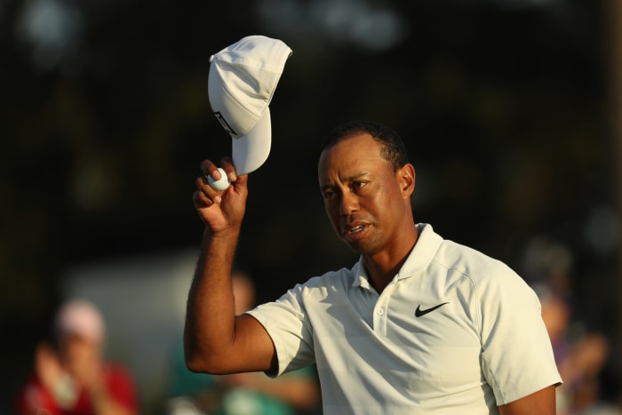 Tiger Woods taking his hat off.