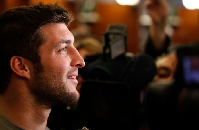 A closeup of Tim Tebow speaking to reporters.
