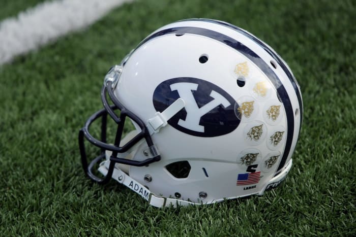 A BYU football helmet sitting on the field.
