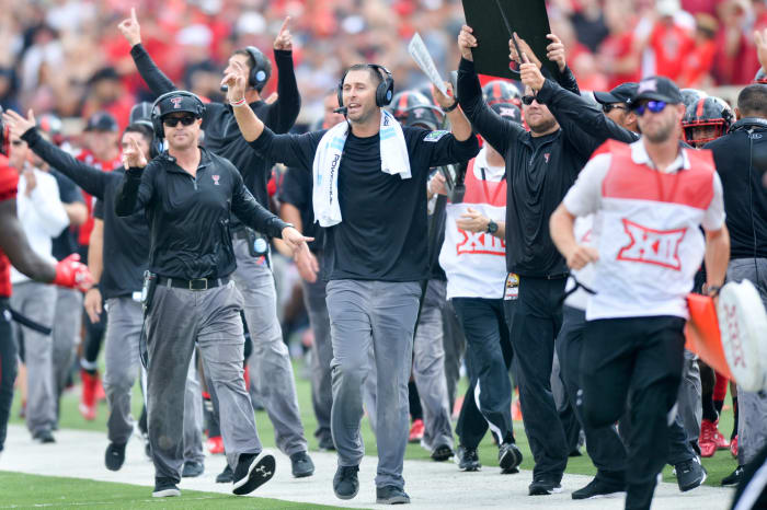 Kliff Kingsbury celebrating on Texas Tech's sideline.